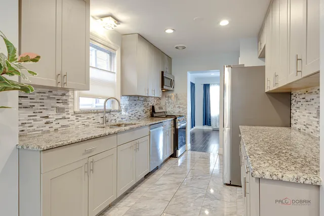 a kitchen with granite countertop cabinets and a sink