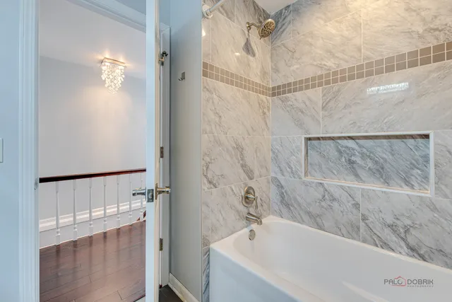 a bathroom with a bathtub and a shower