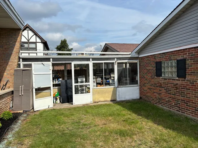 a view of backyard of house with green space