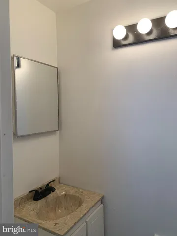 a bathroom with a sink and vanity