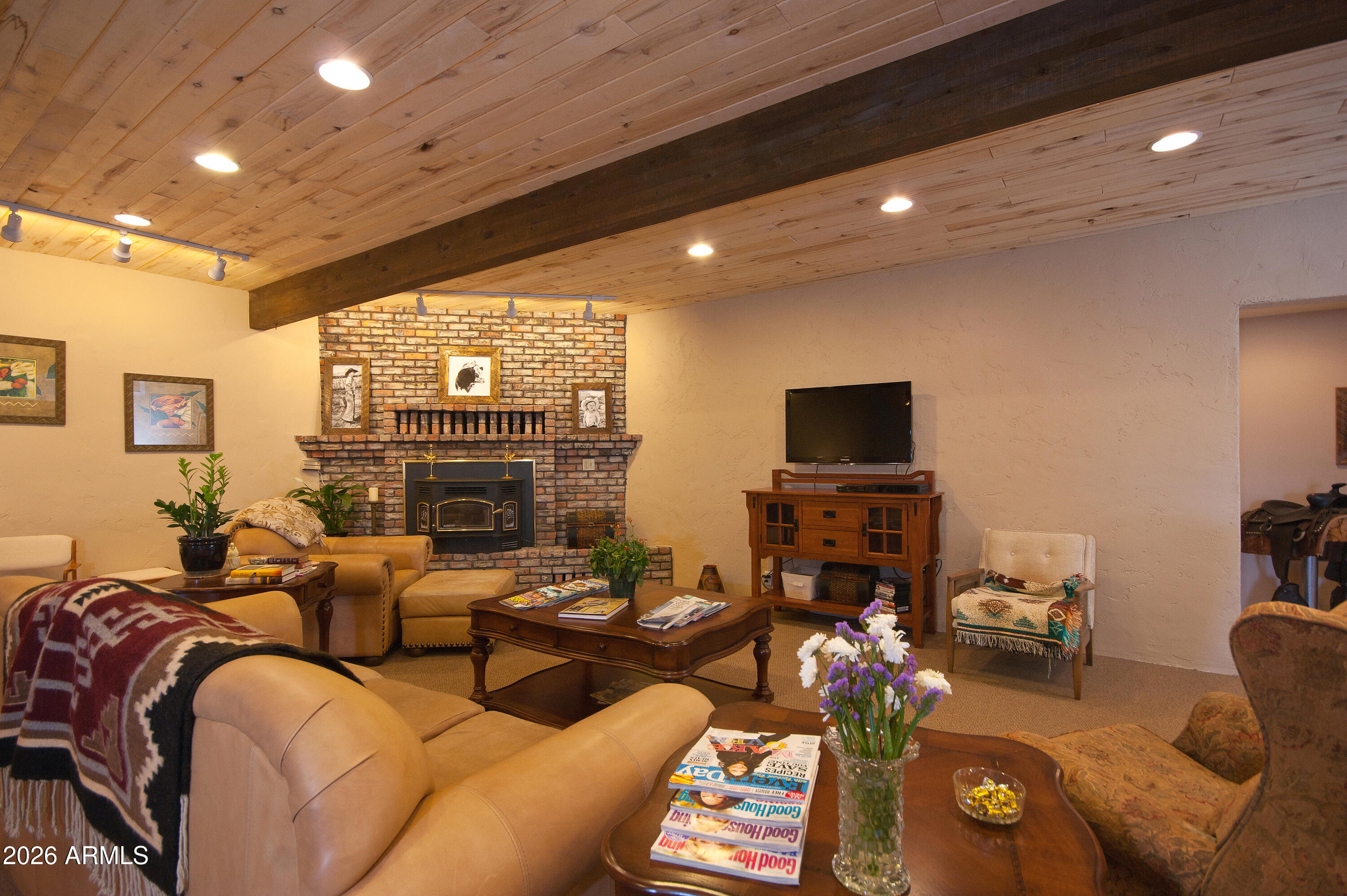 1005 South Page Springs Road Cornville, AZ 86325 - Photo 13 of 43 a living room with fireplace furniture and a flat screen tv