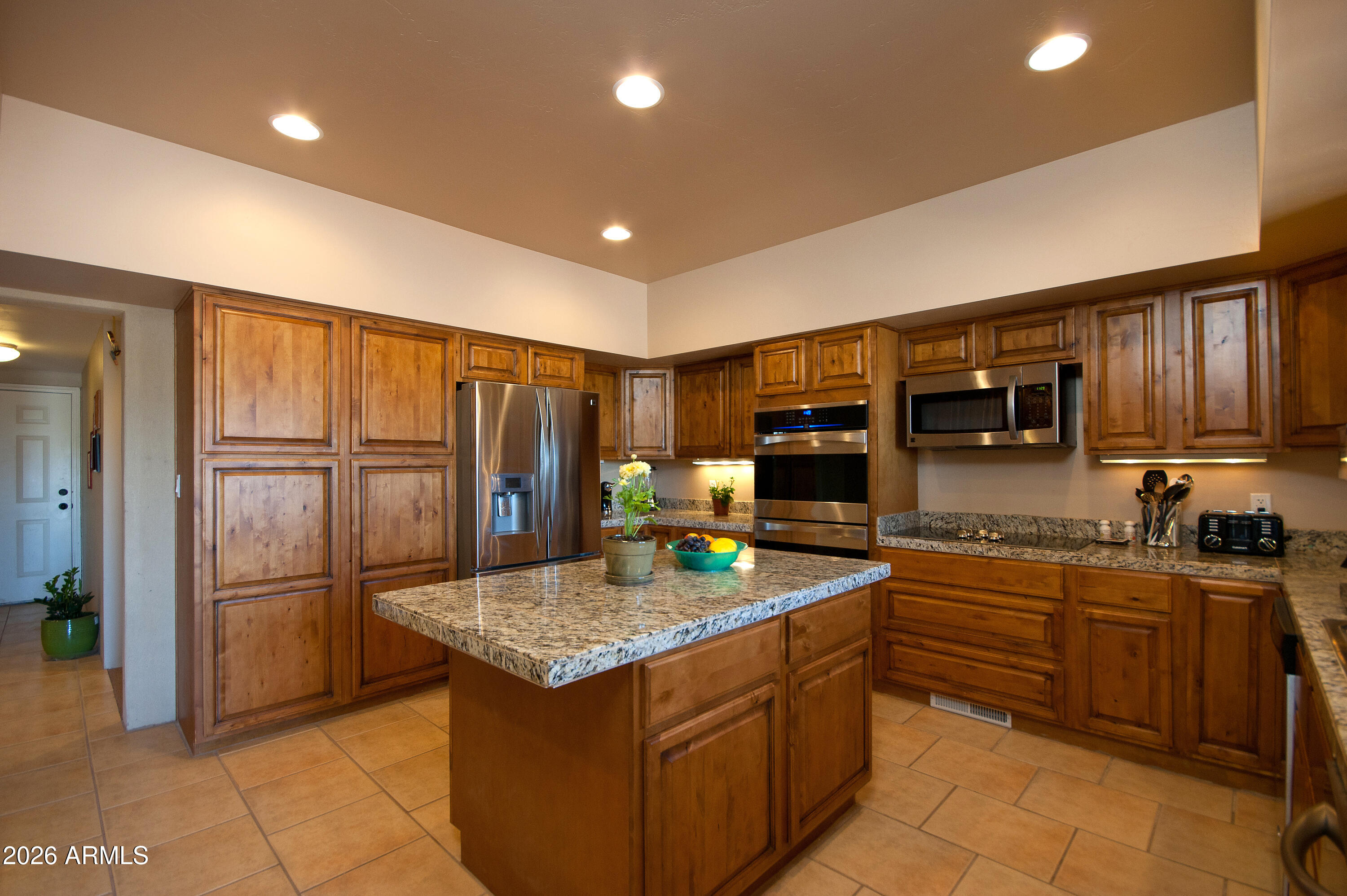 1005 South Page Springs Road Cornville, AZ 86325 - Photo 15 of 43 a kitchen with stainless steel appliances granite countertop a refrigerator and a stove top oven