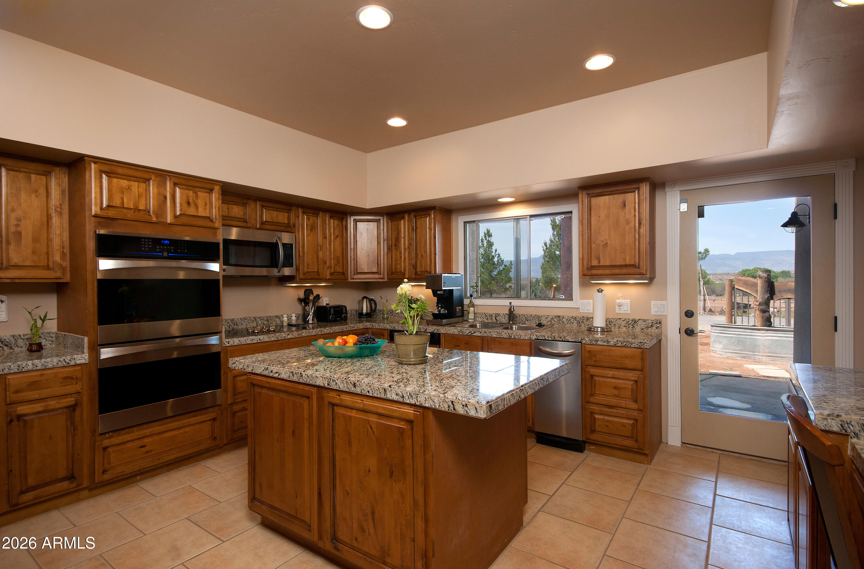 1005 South Page Springs Road Cornville, AZ 86325 - Photo 16 of 43 a kitchen with stainless steel appliances granite countertop a stove a sink and a refrigerator