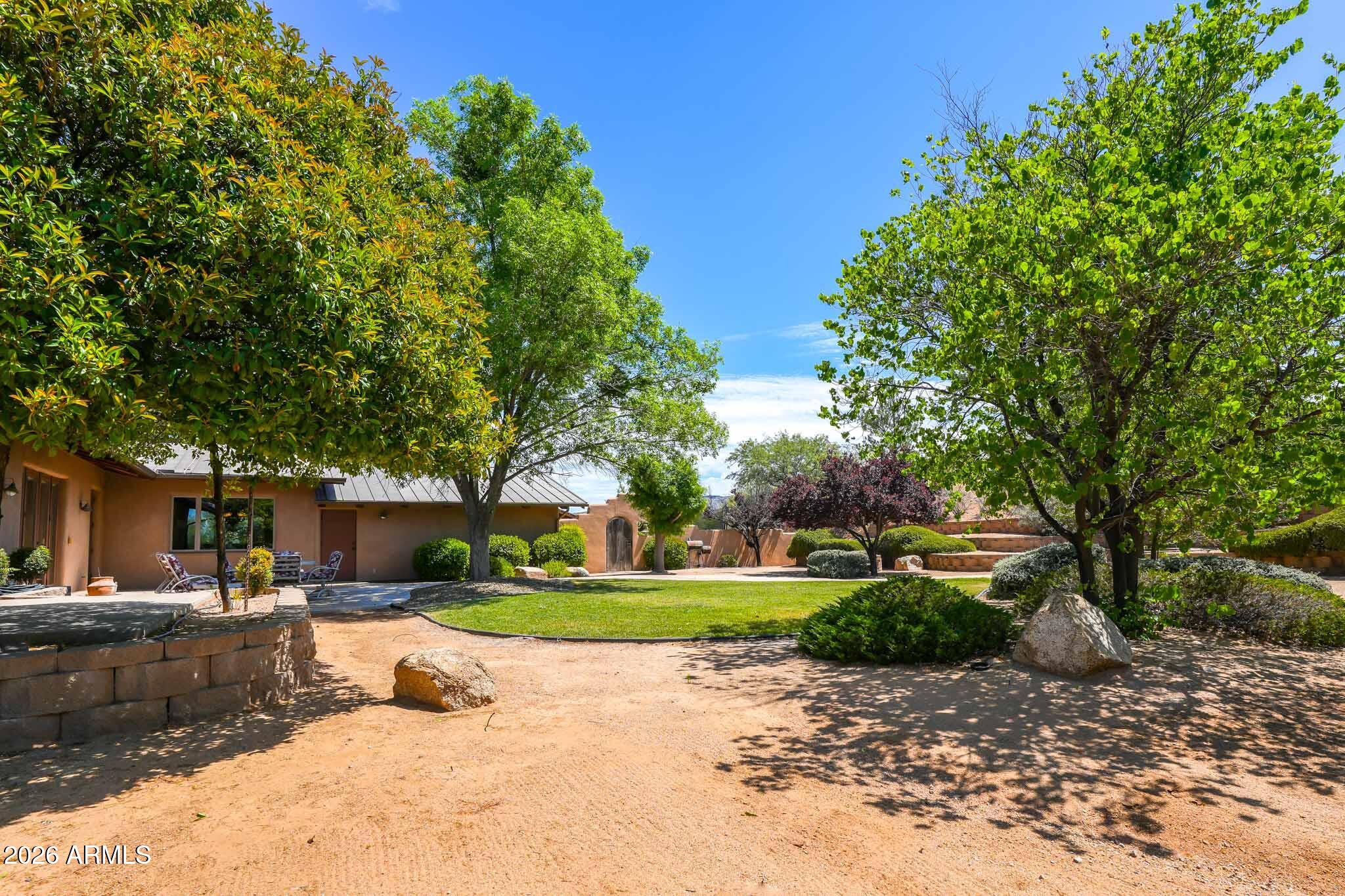 1005 South Page Springs Road Cornville, AZ 86325 - Photo 21 of 43 a front view of a house with a yard and tree s