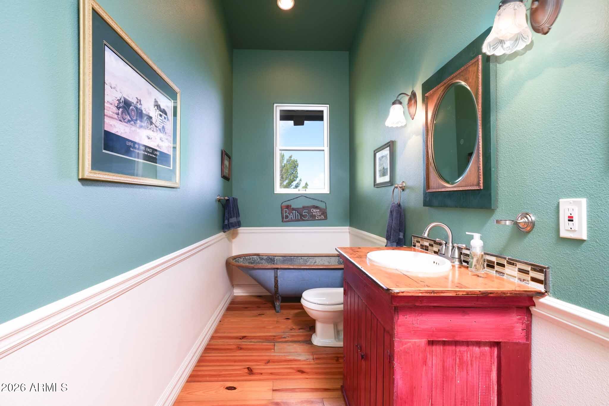 1005 South Page Springs Road Cornville, AZ 86325 - Photo 36 of 43 a bathroom with a toilet a sink and mirror