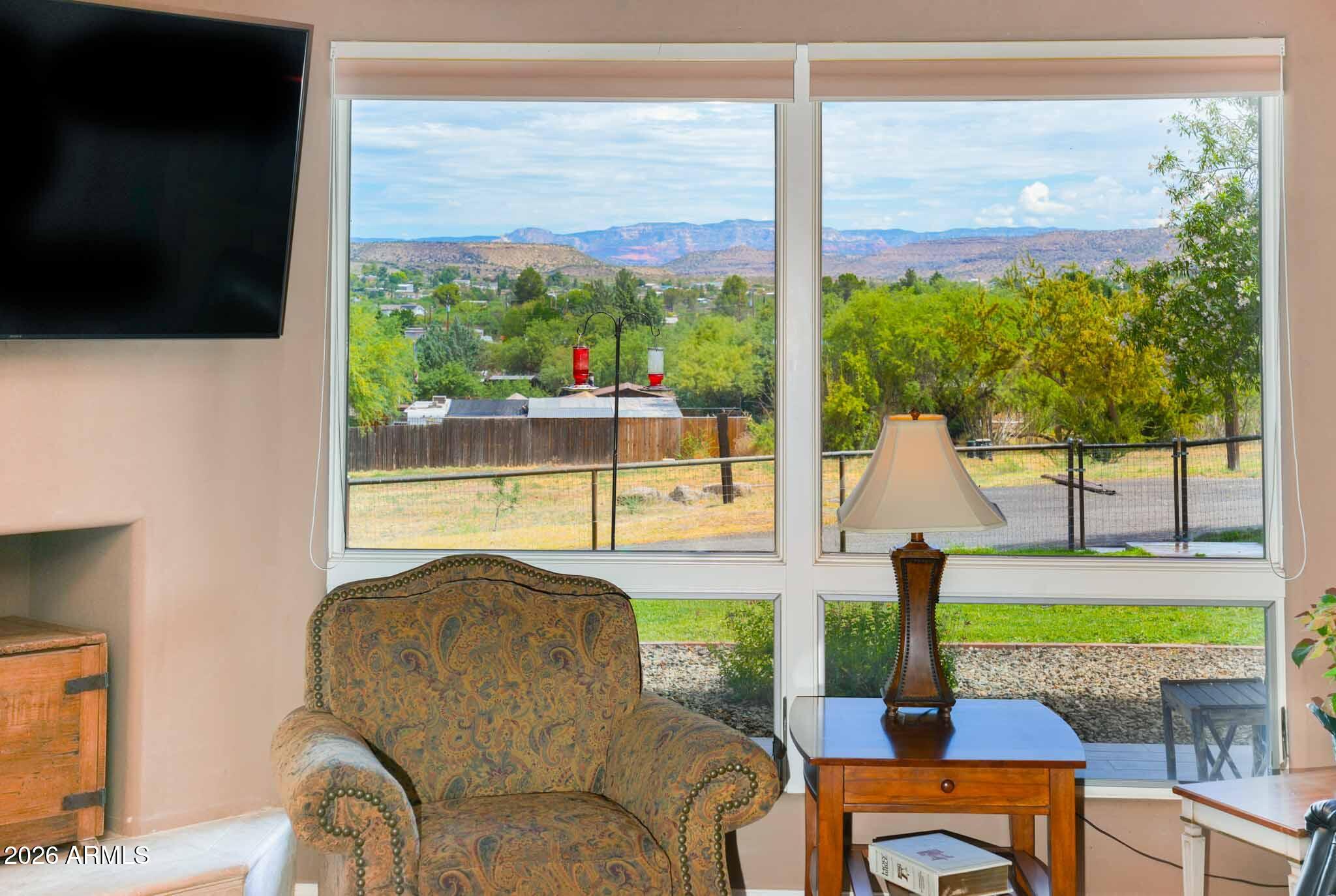 1005 South Page Springs Road Cornville, AZ 86325 - Photo 40 of 43 a living room filled with furniture and a floor to ceiling window
