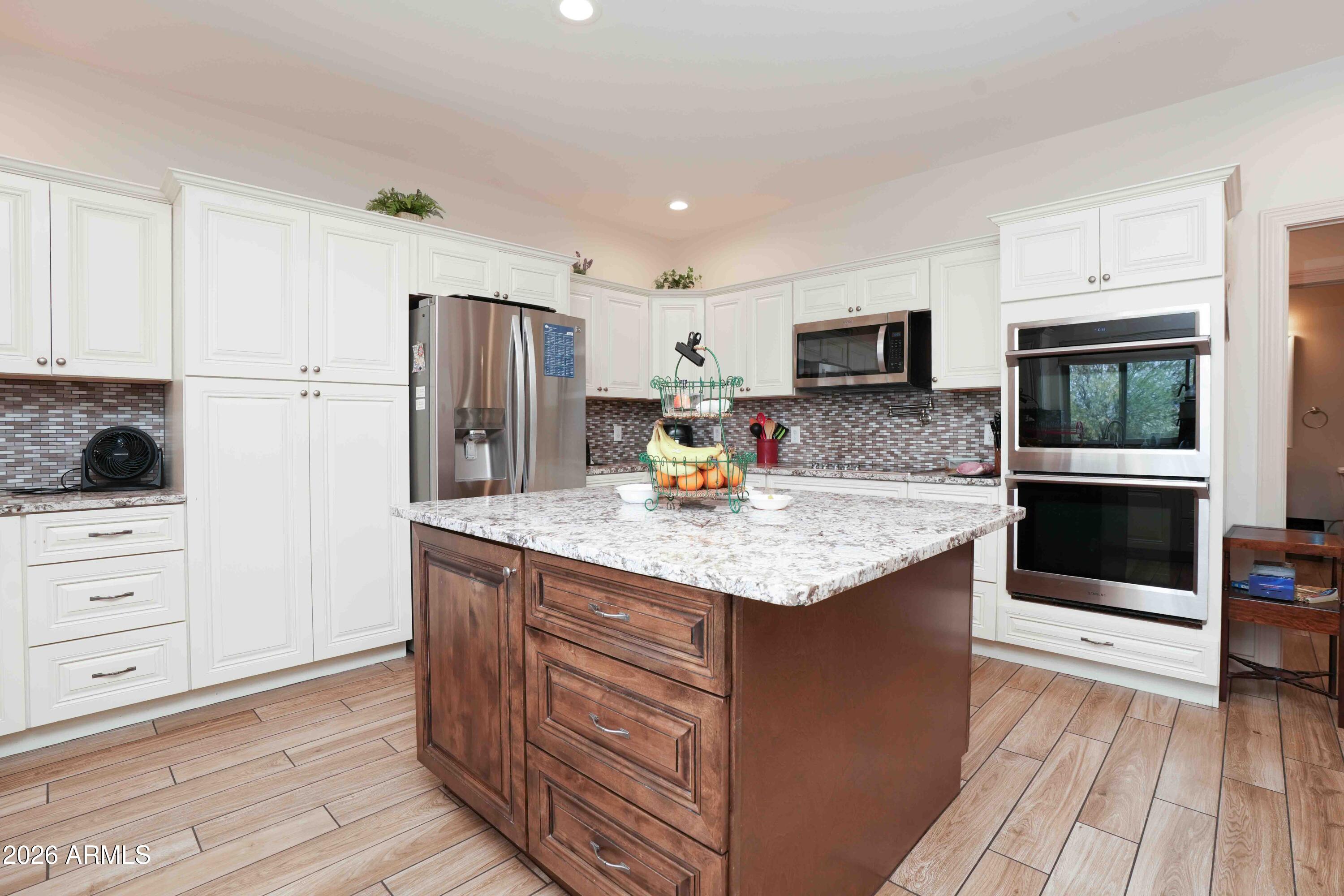 1005 South Page Springs Road Cornville, AZ 86325 - Photo 5 of 43 a kitchen with stainless steel appliances granite countertop a kitchen island hardwood floor sink and stove