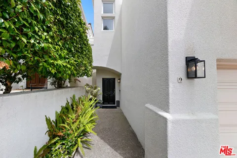view of a house with potted plants