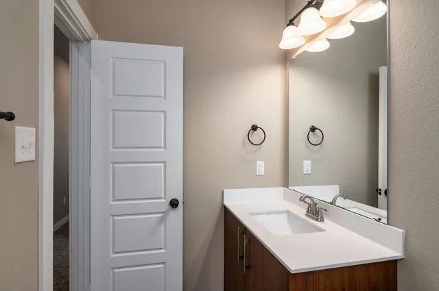 a bathroom with a sink vanity and a mirror