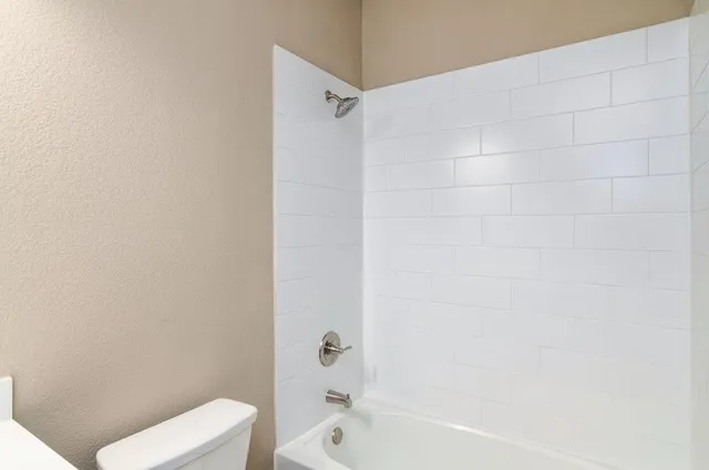 a bathroom with a bathtub and a toilet