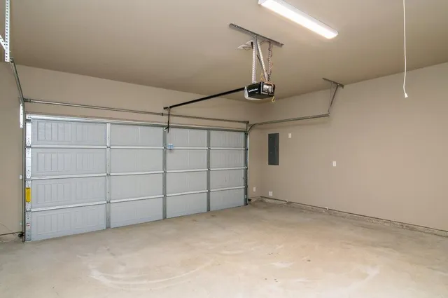 a view of an empty room with wooden fence