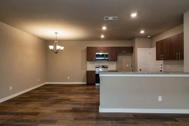a view of kitchen with microwave and cabinets