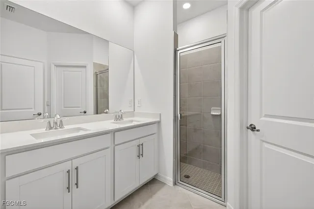 a bathroom with a double vanity sink and mirror