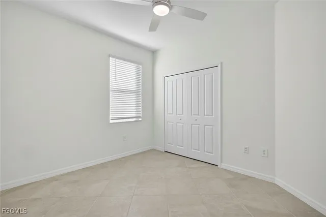 an empty room with windows and closet