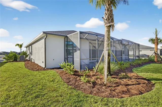 a view of a house with a small yard and plants