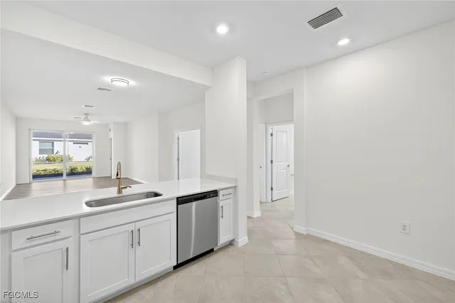 a spacious bathroom with a granite countertop sink mirror and