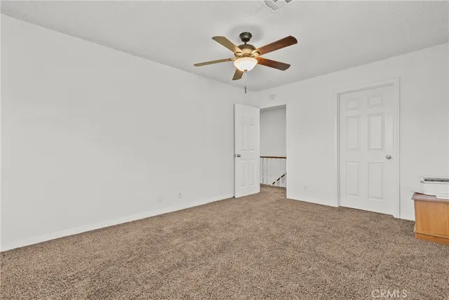 a view of a hallway with windows and stairs