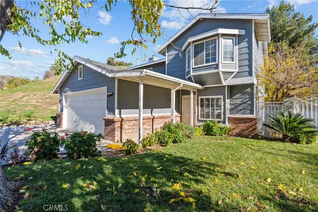 a view of front of house with a yard