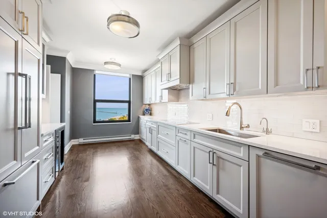 a kitchen with granite countertop a sink stainless steel appliances and cabinets