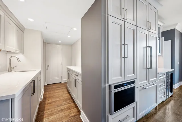 a kitchen with granite countertop white cabinets and white appliances
