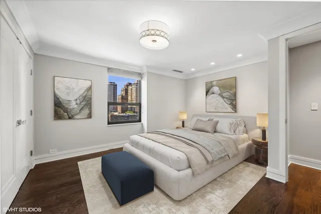 a bedroom with a large bed and a painting on the wall