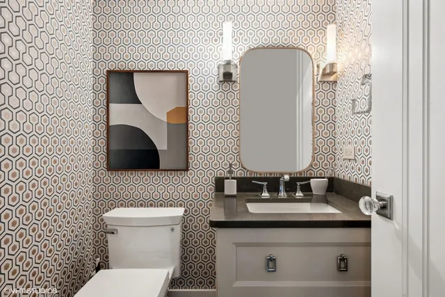 a bathroom with a toilet a sink and mirror