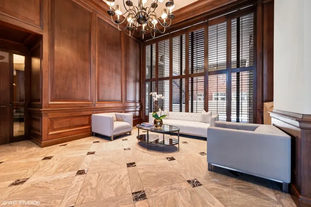 a living room with furniture and large windows