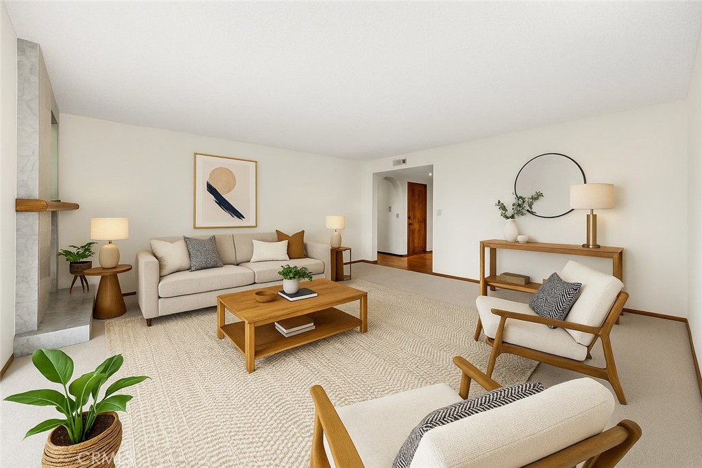 a living room with furniture and a potted plant