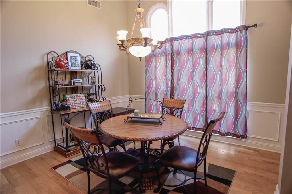 3875 Spring Manor Court Loganville, GA 30052 - Photo 12 of 23 a view of a dining room with furniture and wooden floor