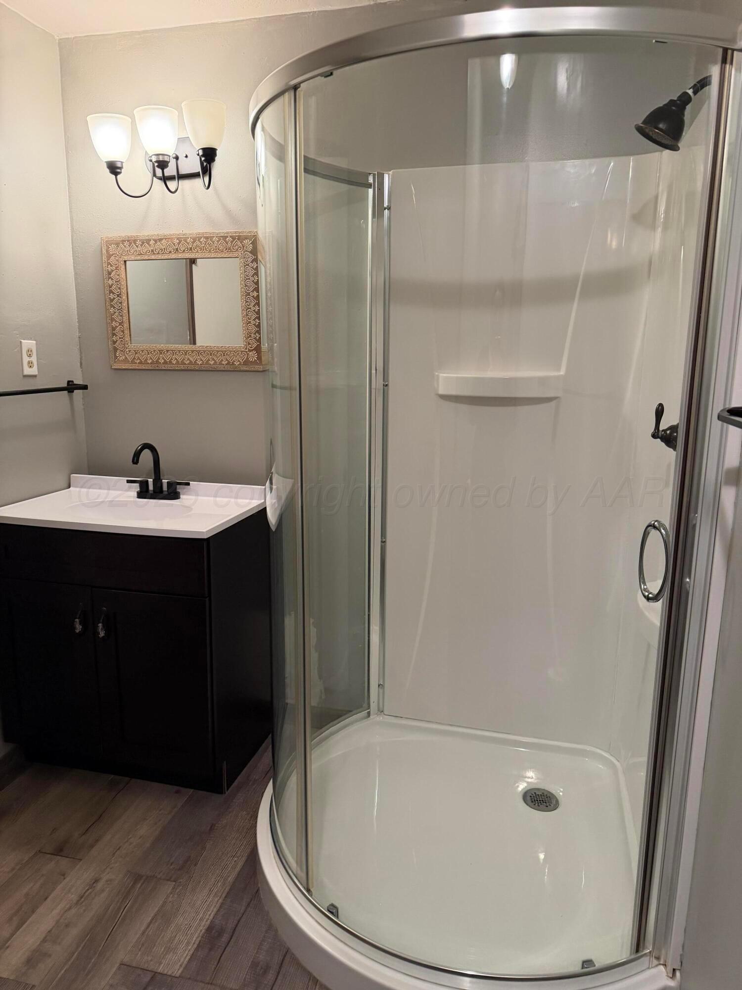 1313 Davis Street Borger, TX 79007 - Photo 12 of 15 a bathroom with a sink a toilet and shower