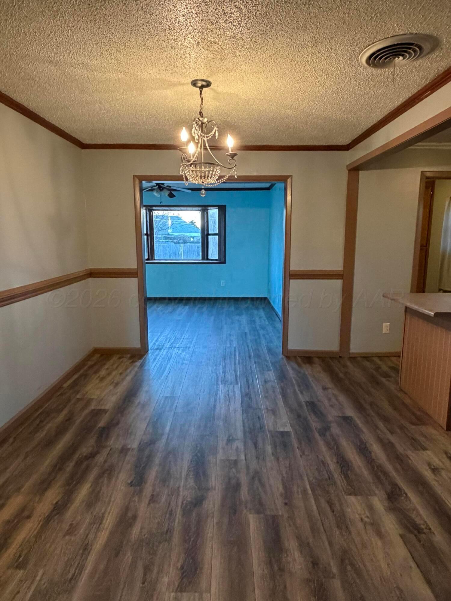 1313 Davis Street Borger, TX 79007 - Photo 5 of 15 a view of a livingroom with wooden floor