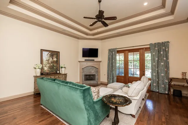 a living room with furniture a fireplace and a flat screen tv
