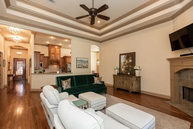 a living room with furniture a fireplace and a flat screen tv