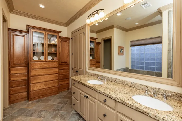 a bathroom with a granite countertop sink mirror and