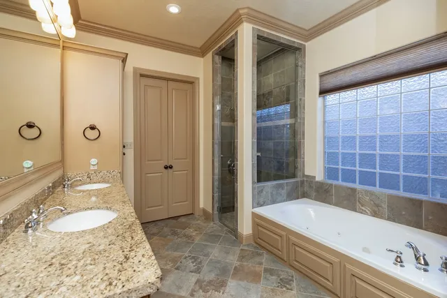 a bathroom with a tub a sink and a shower