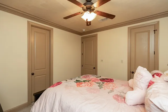 a bedroom with a bed and a chandelier