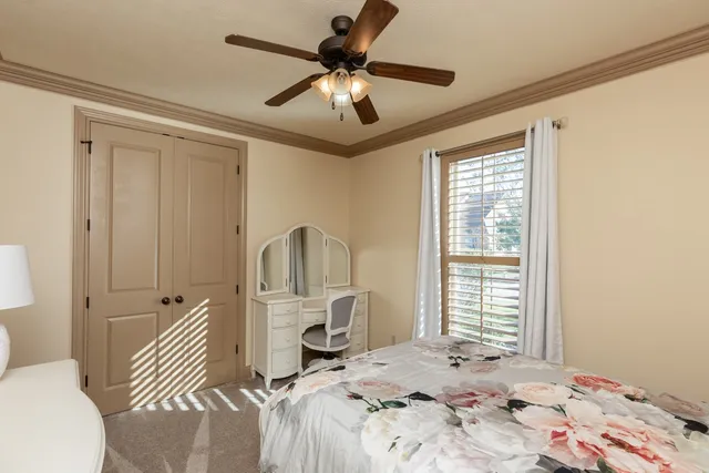 a bedroom with a bed and a chandelier