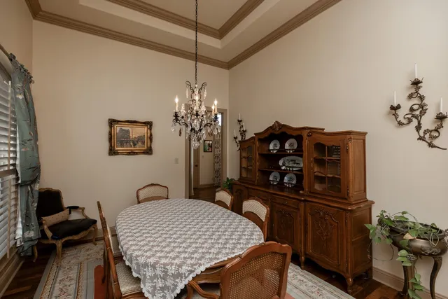 a view of a dining room with furniture and chandelier