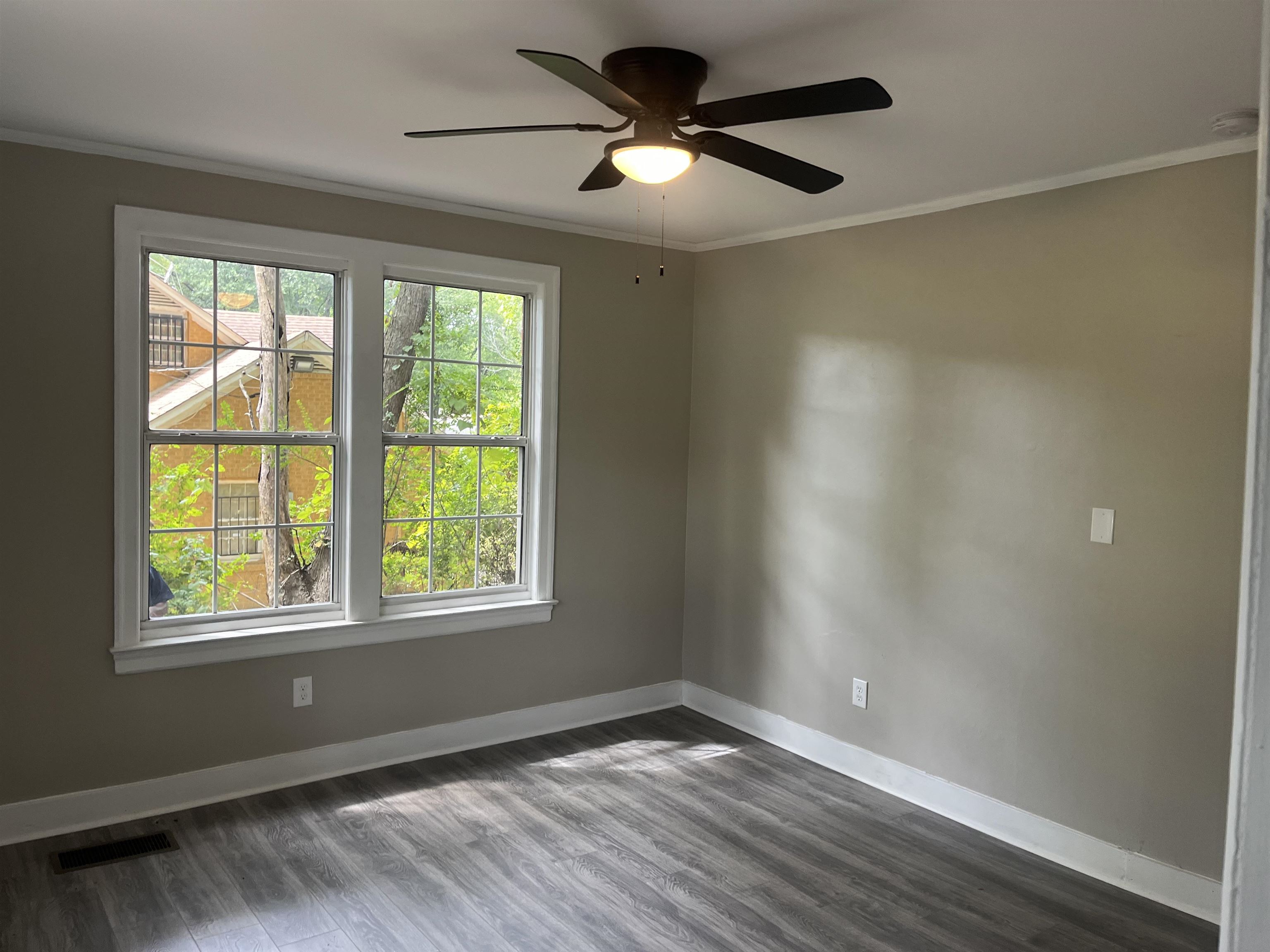 754 Hale Road Memphis, TN 38116 - Photo 7 of 9 a view of an empty room with a window and wooden floor