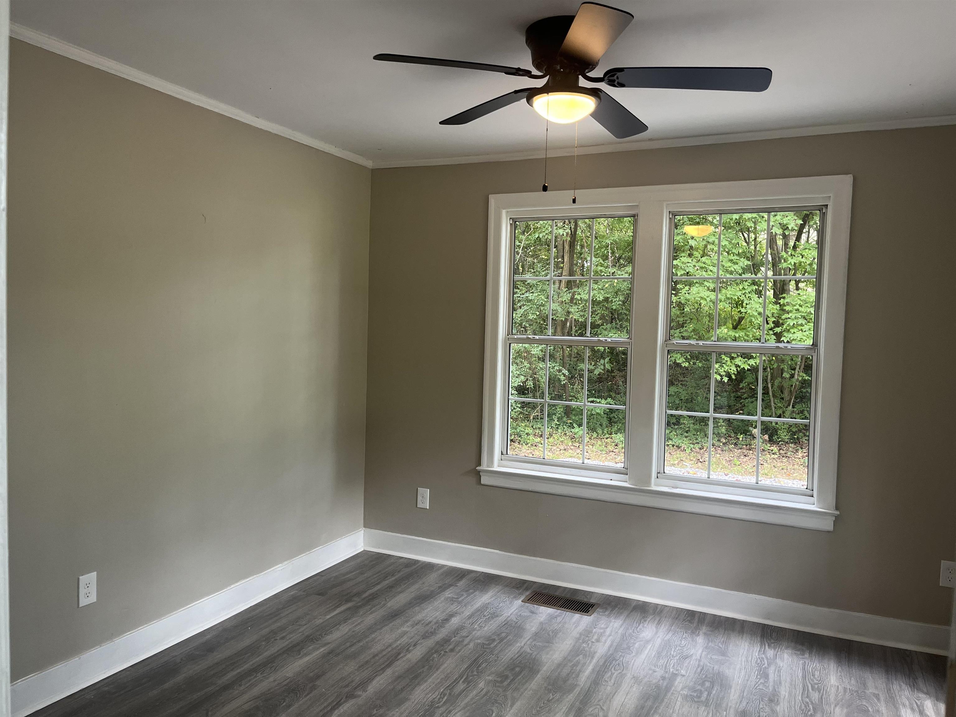 754 Hale Road Memphis, TN 38116 - Photo 9 of 9 a view of an empty room with wooden floor and a window