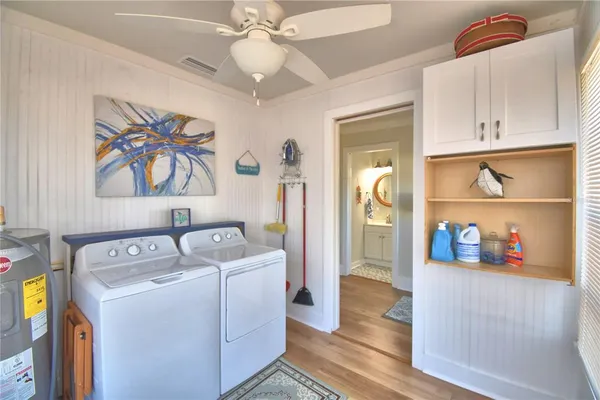 a dining room with furniture a chandelier and wooden floor