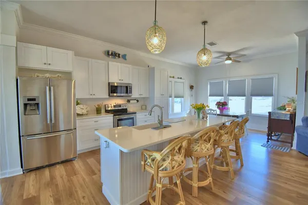 a kitchen with stainless steel appliances granite countertop a stove a sink and a refrigerator