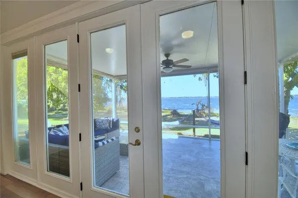 a view of a dining room with furniture a chandelier and wooden floor