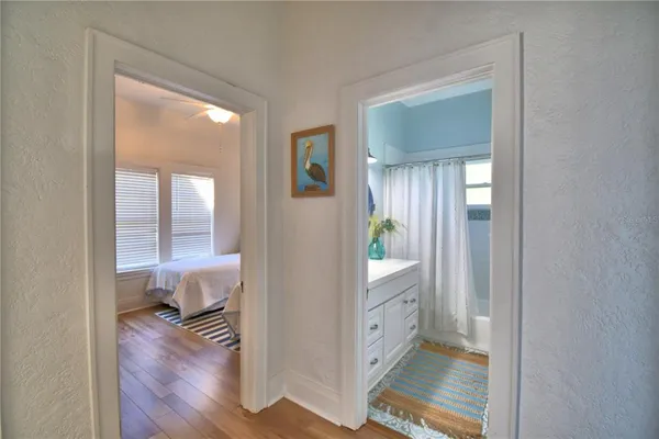 a bedroom with two beds and a chandelier