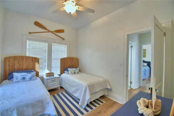 a bedroom with a bed and a chandelier