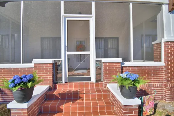 a living room with furniture wooden floor and a window
