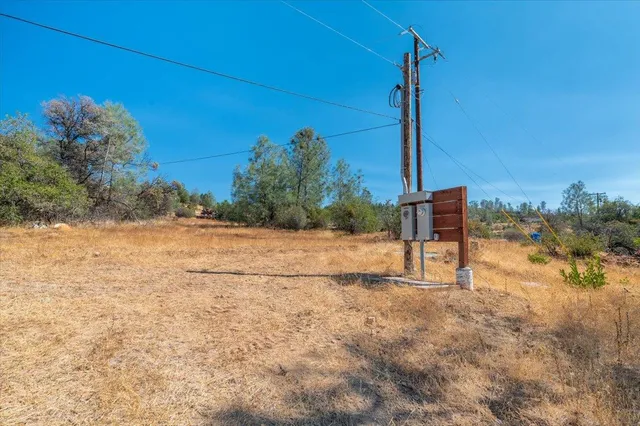 a view of a yard with wooden fence