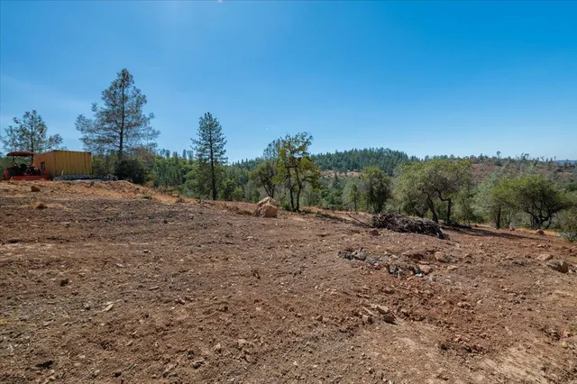 a view of a dirt road with a building in the background
