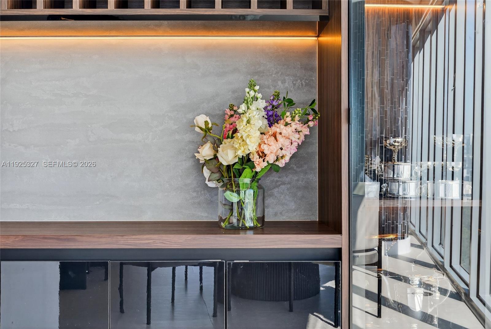 601 Northeast 36th Street, Unit 1101 Miami, FL 33137 - Photo 23 of 69 a vase of flowers sitting on a table with chairs