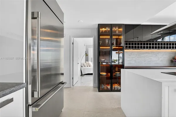 a dining room with furniture and floor to ceiling windows